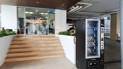 a drink vending machine in front of a store at Harmony Living Condominium in Makkasan