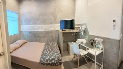 a small room with a small bed and a desk at Hive28 in Bang Kapi