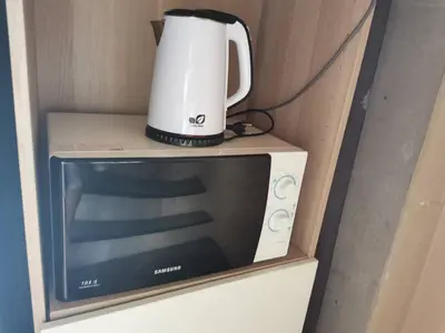 a coffee pot sitting on top of a microwave at Hive28 in Bang Kapi