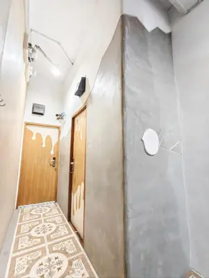 a hallway with a door and a tile floor at Hive28 in Bang Kapi