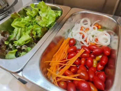 two metal trays filled with vegetables and lettuce at NORN Canalside Bangkok Hotel โรงแรมนอนริมคลอง in Bangkok Noi