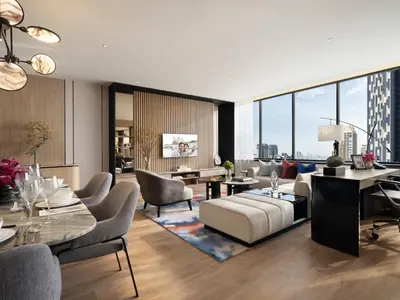 a living room filled with furniture and a large window at Ascott Embassy Sathorn Bangkok in Bangkok