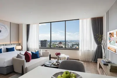 a hotel room with a bed and a large window at Ascott Embassy Sathorn Bangkok in Bangkok