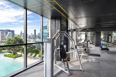 a gym with a view of the city at Ascott Embassy Sathorn Bangkok in Bangkok