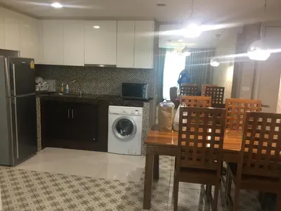 a kitchen with a washing machine and a table and chairs at Liv at 5 room41 in Bangkok
