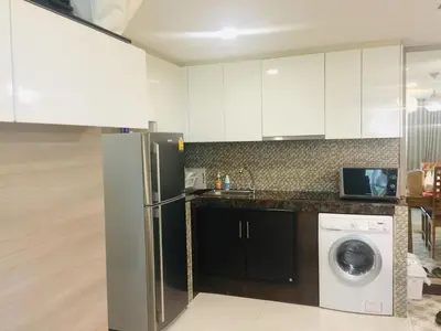 a kitchen with a refrigerator and a washer and dryer at Liv at 5 room41 in Bangkok