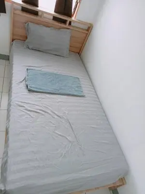 a bed in the corner of a room at 5บีบี 5BB guest house in Bangkok