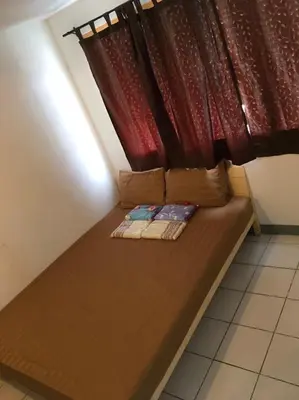 a bed in a room with a red curtain at 5บีบี 5BB guest house in Bangkok