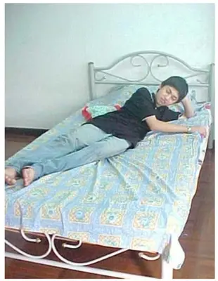 a young girl laying on a bed at 5บีบี 5BB guest house in Bangkok