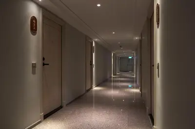 a hallway with a long corridor with white walls at The Path Siam in Bangkok