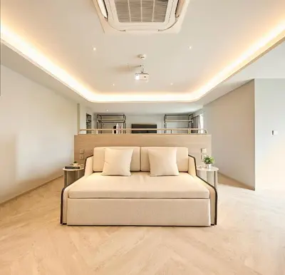 a room with a couch with two pillows on it at The Path Siam in Bangkok