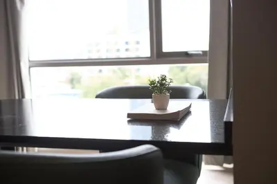 a table with a plant sitting on top of it at The Path Siam in Bangkok