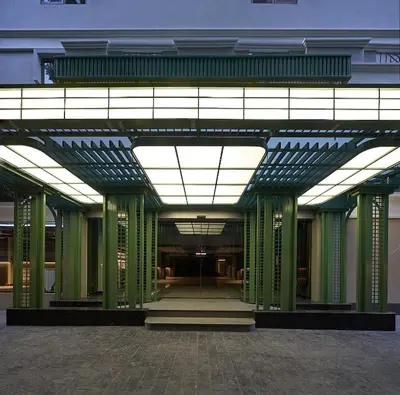 a large building with green columns and a ceiling at The Path Siam in Bangkok