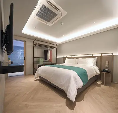 a bedroom with a bed and an air conditioner at The Path Siam in Bangkok