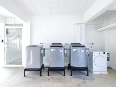 a row of machines sitting in a room at The zai Apartment in Ban Krathum Lom