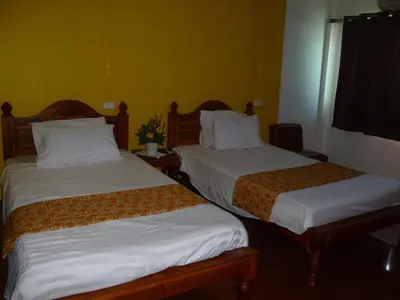 two beds in a hotel room with white sheets at Room For You in Bangkok