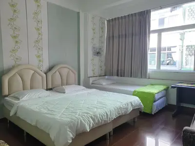 a bedroom with a large bed and a window at Room For You in Bangkok