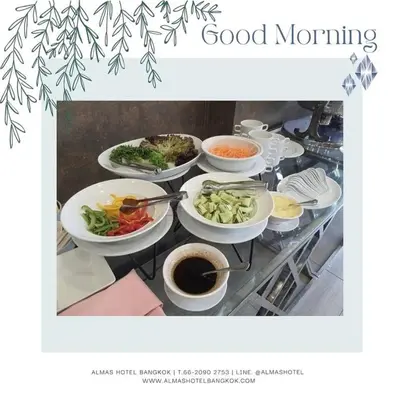 a table with bowls of food and a plate of food at Almas Hotel Bangkok in Bangkok