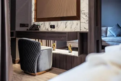 a living room with a couch and a chair at The One Smart Living in Bangkok