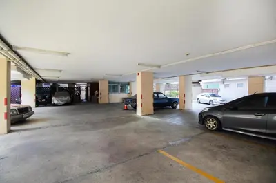 an empty parking lot with cars parked in it at Mee sook Hotel and Residence in Nonthaburi
