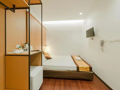 a small bedroom with a bed and a sink at Watergate City in Bangkok