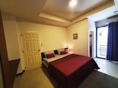 a bedroom with a bed with a red blanket at 552 Residence in Bangkok