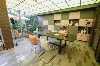a dining room with a table and chairs at Seekers Finders Rama IV Hotel SureStay Collection by BW in Bangkok