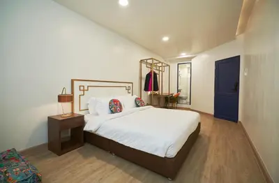 a bedroom with a large bed and a blue door at Sweet's Escape in Bangkok