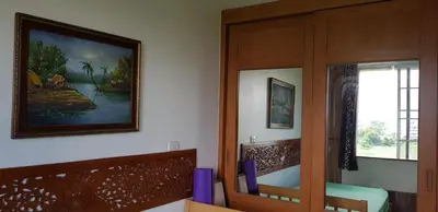 a room with two chairs and a painting on the wall at The Park Land Bangna by Nudda in Bangkok