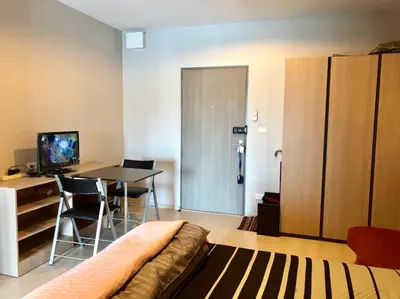 a living room with a couch and a table with chairs at New condominium on Sukhumvit Road 