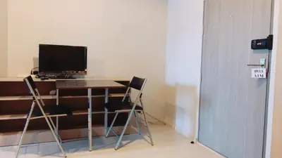 a desk with two chairs and a computer monitor on it at New condominium on Sukhumvit Road 