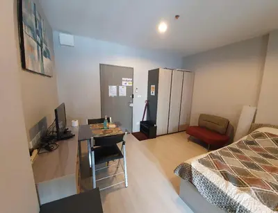 a bedroom with a bed and a desk with a computer at New condominium on Sukhumvit Road 
