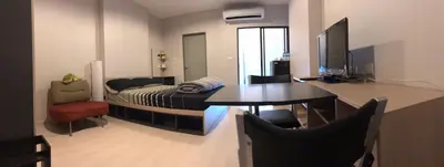 a bedroom with a desk and a bed and a table at New condominium on Sukhumvit Road 