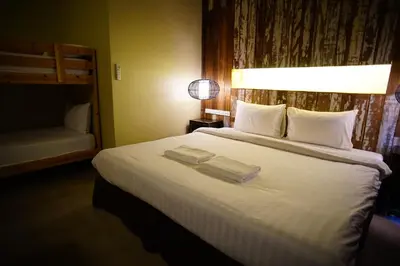 a bedroom with a large bed with two towels on it at Villa Bangkok in Bangkok