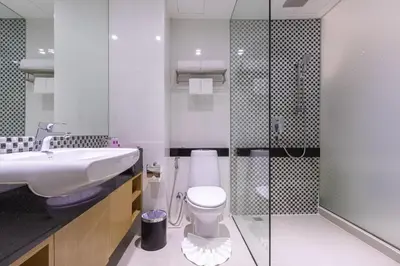 a bathroom with a toilet and a sink and a shower at Hotel Icon Bangkok Sukhumvit 2 in Bangkok