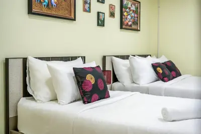 two beds with pillows on them in a room at At FOUR-6 Bed, CITY CENTER, Nana BTS, MBK, Central World, Siam in Bangkok