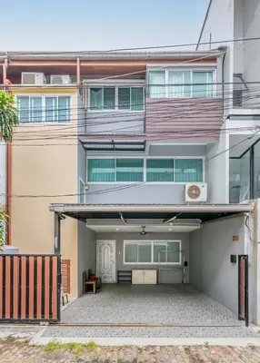 an apartment building with a garage in front of it at At FOUR-6 Bed, CITY CENTER, Nana BTS, MBK, Central World, Siam in Bangkok