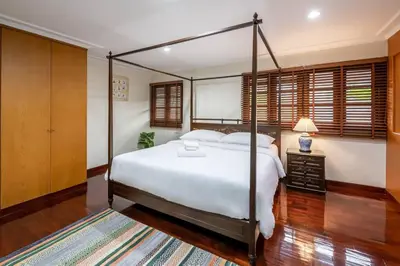 a bedroom with a large white bed and wooden floors at AT NANA-5Bed, CITY CENTER, Nana BTS, MBK, Central World, Siam in Bangkok