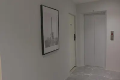 a picture hanging on a wall in a room at Nato house Ekkamai in Bangkok