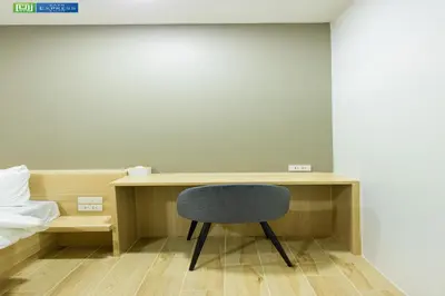 a desk with a black chair in a room at Zayn Express & Suites in Bangkok