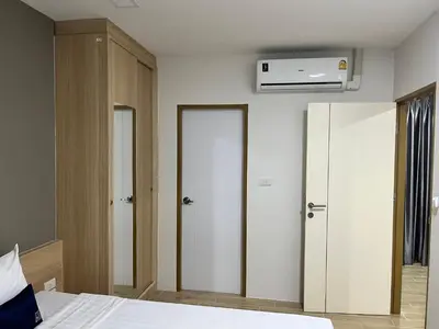 a bedroom with a bed and a air conditioner at Zayn Express & Suites in Bangkok