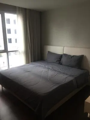 a bed in a bedroom with a large window at Livat5r1042 in Makkasan