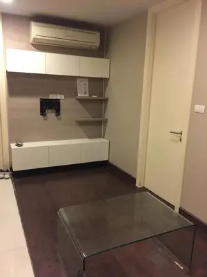 a room with a glass table in a room at Livat5r1042 in Makkasan