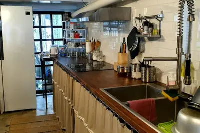 a kitchen with a sink and a counter top at Beautiful 5 Story Family House in Bangkok