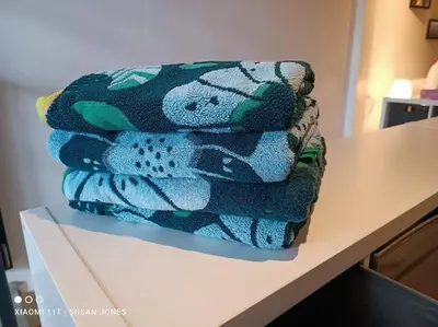 a pile of towels sitting on top of a counter at Beautiful 5 Story Family House in Bangkok