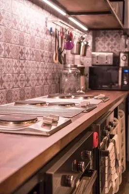 a kitchen with a counter with plates and utensils at Beautiful Super Modern Gigantic Designer Home in Bangkok