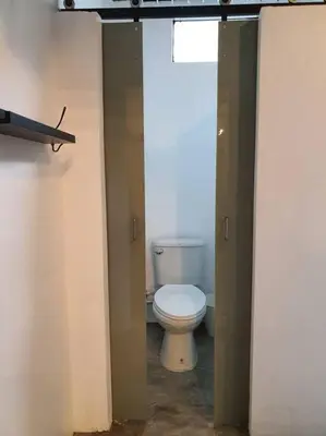 a bathroom with a white toilet in a room at Great House for Families and Big Groups in Bangkok