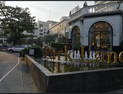 a fountain in the street in front of a building at Nato House Ekkamai -BTS Ekkamai with balcony in Bangkok