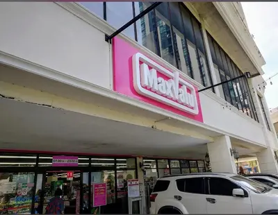 a walmart store with a car parked in front of it at Nato House Ekkamai -BTS Ekkamai with balcony in Bangkok