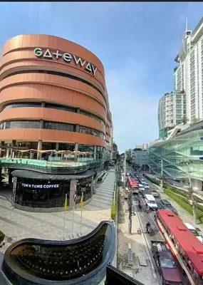 a large building with a sign on the side of it at Nato House Ekkamai -BTS Ekkamai with balcony in Bangkok